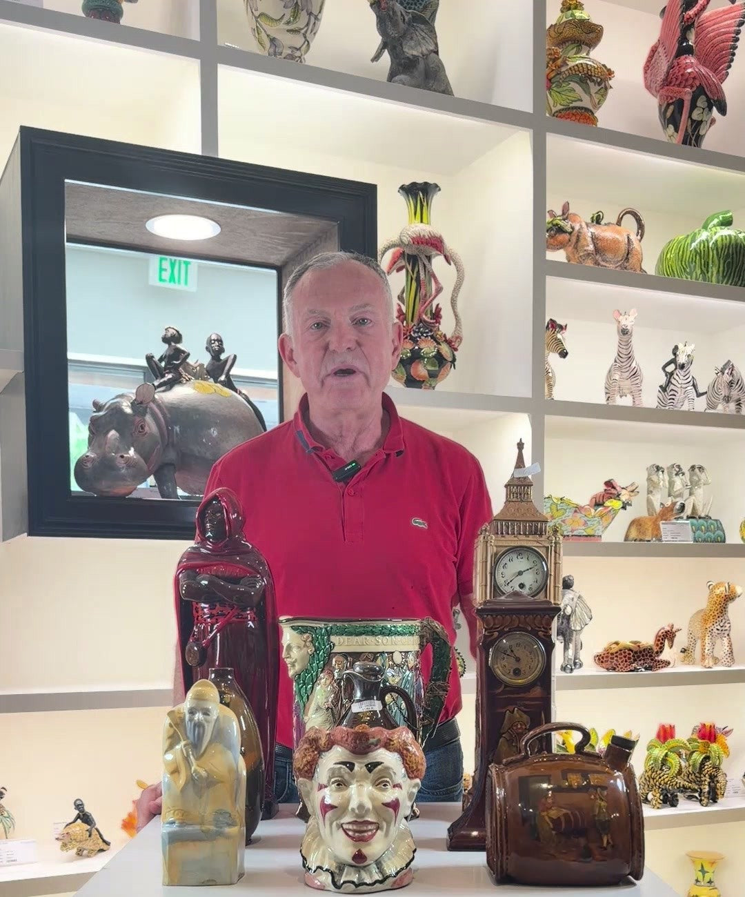 Ed Pascoe with a table of Royal Doulton flambé, Kingsware and a red-haired Clown character jug