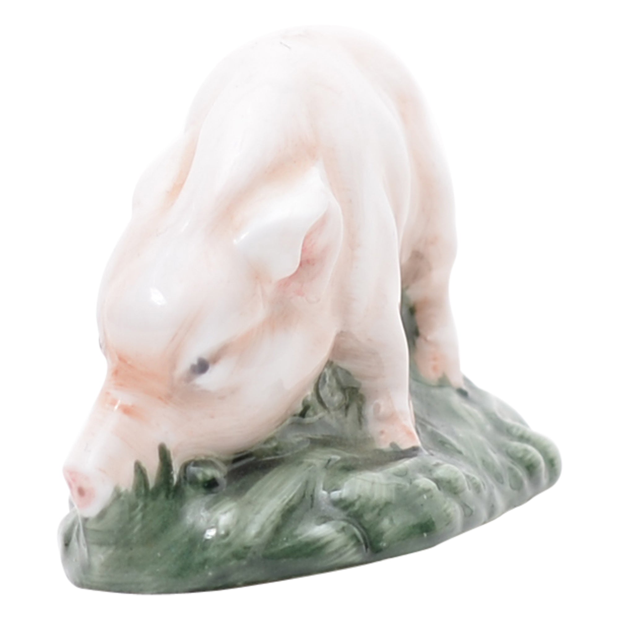 Pink piglet on green grassy mound