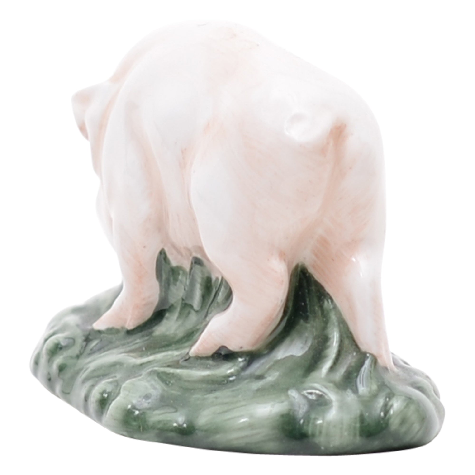 Pink piglet on green grassy mound