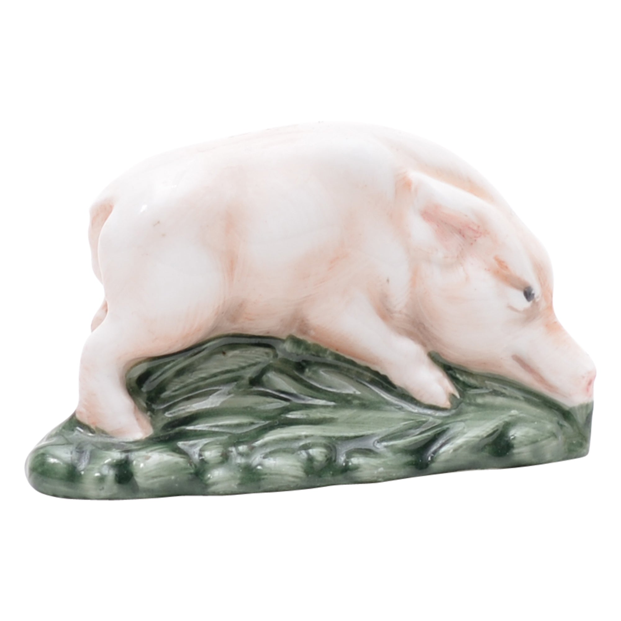 Pink piglet on green grassy mound