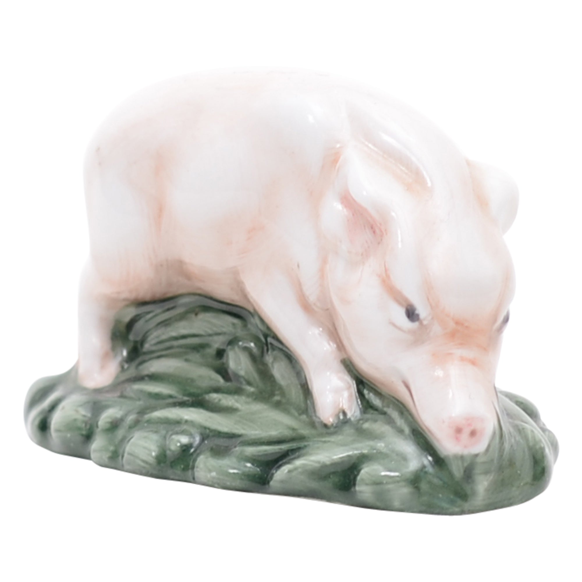 Pink piglet on green grassy mound