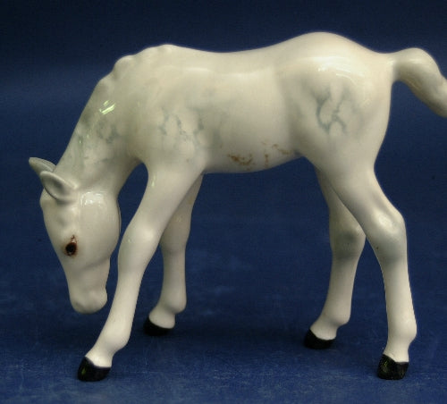 Grazing foal sculpture