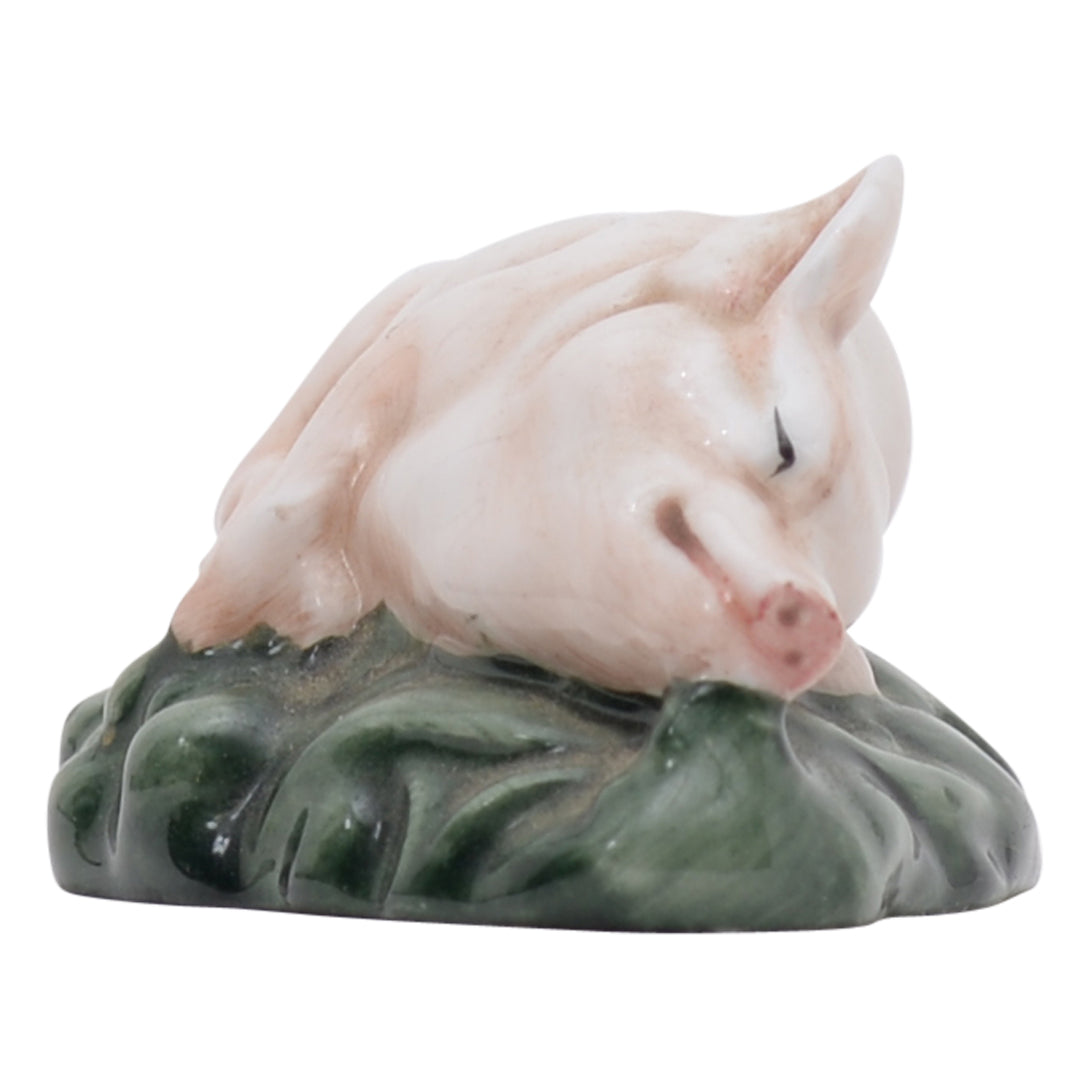 Piglet laying down on side sculpture