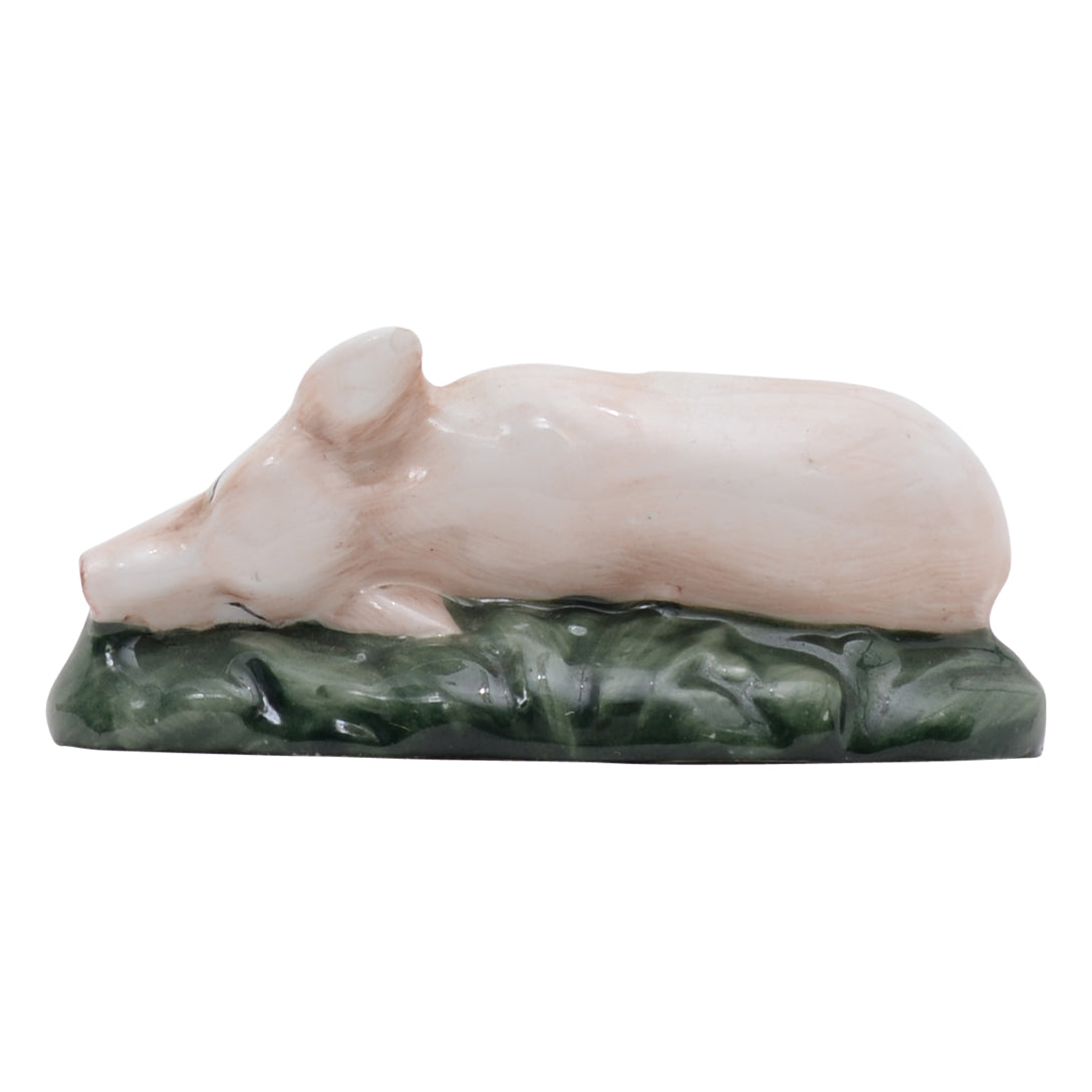 Piglet laying down on side sculpture