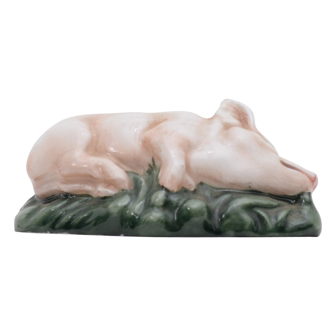 Piglet laying down on side sculpture